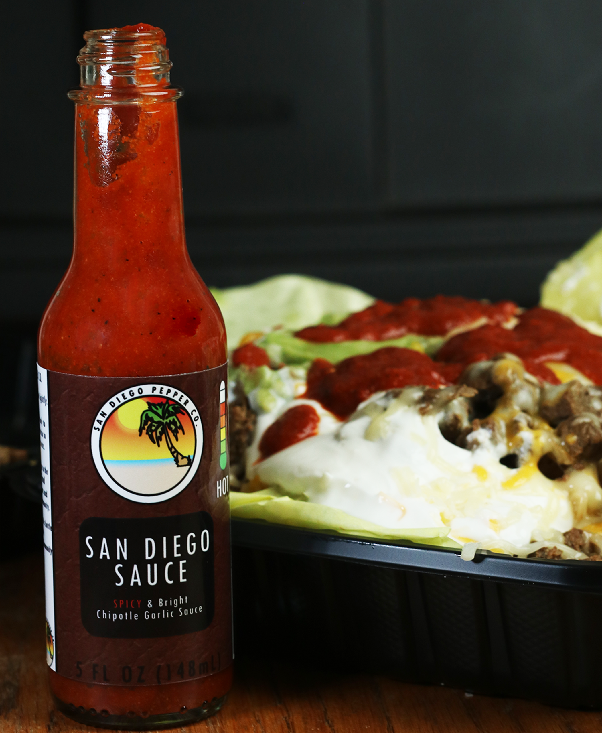 Carne Asada Fries and San Diego Hot Sauce side by side