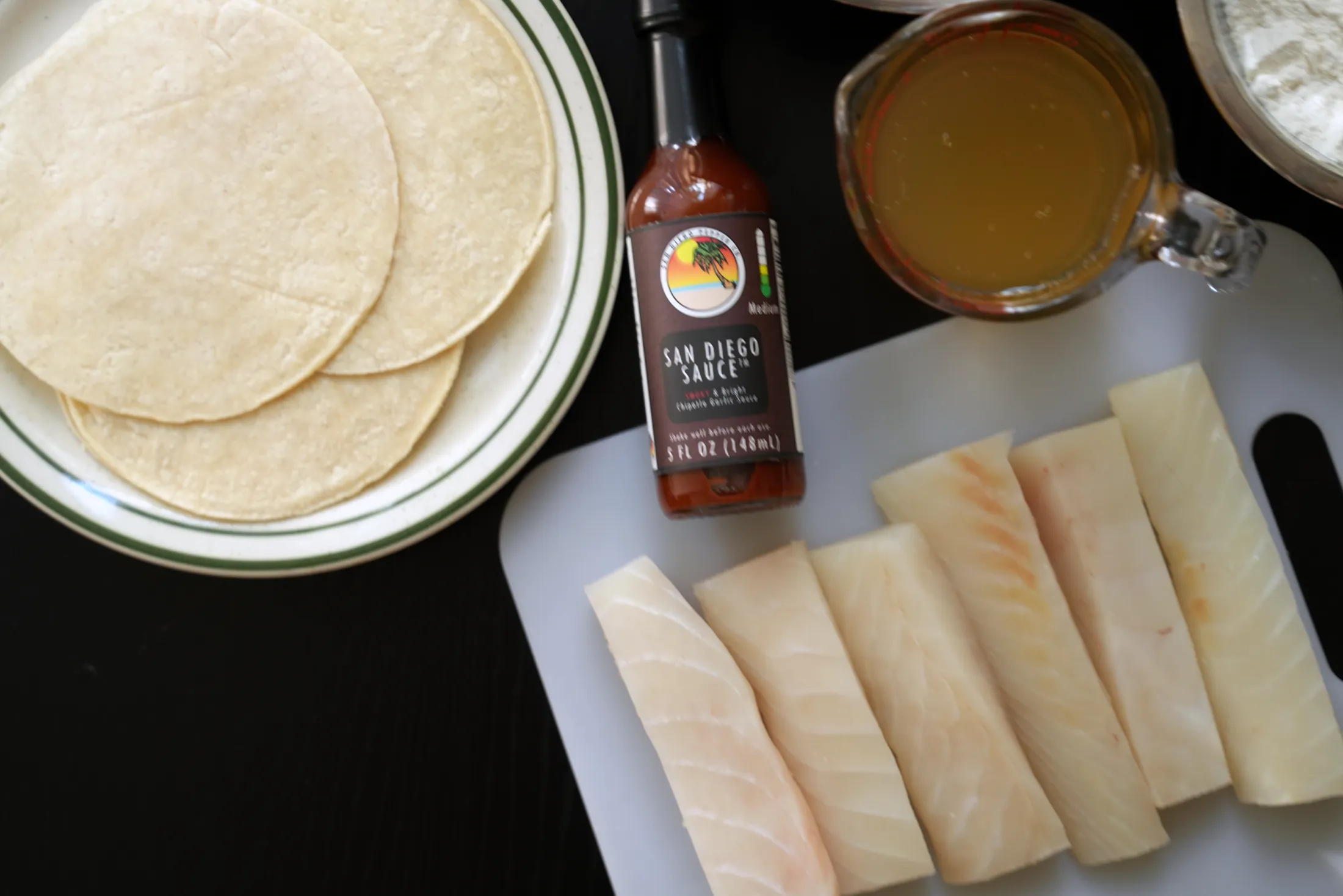 San Diego Sauce surrounded by other essential ingredients for San Diego Fish Tacos
