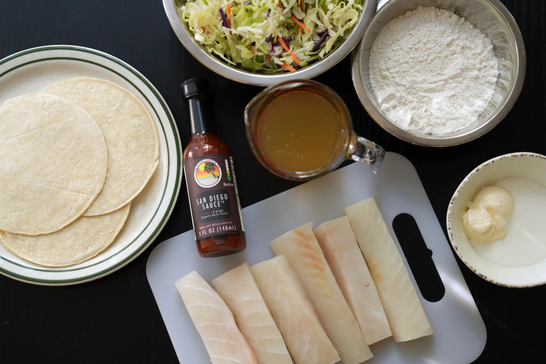 San Diego Sauce surrounded by other essential ingredients for San Diego Fish Tacos