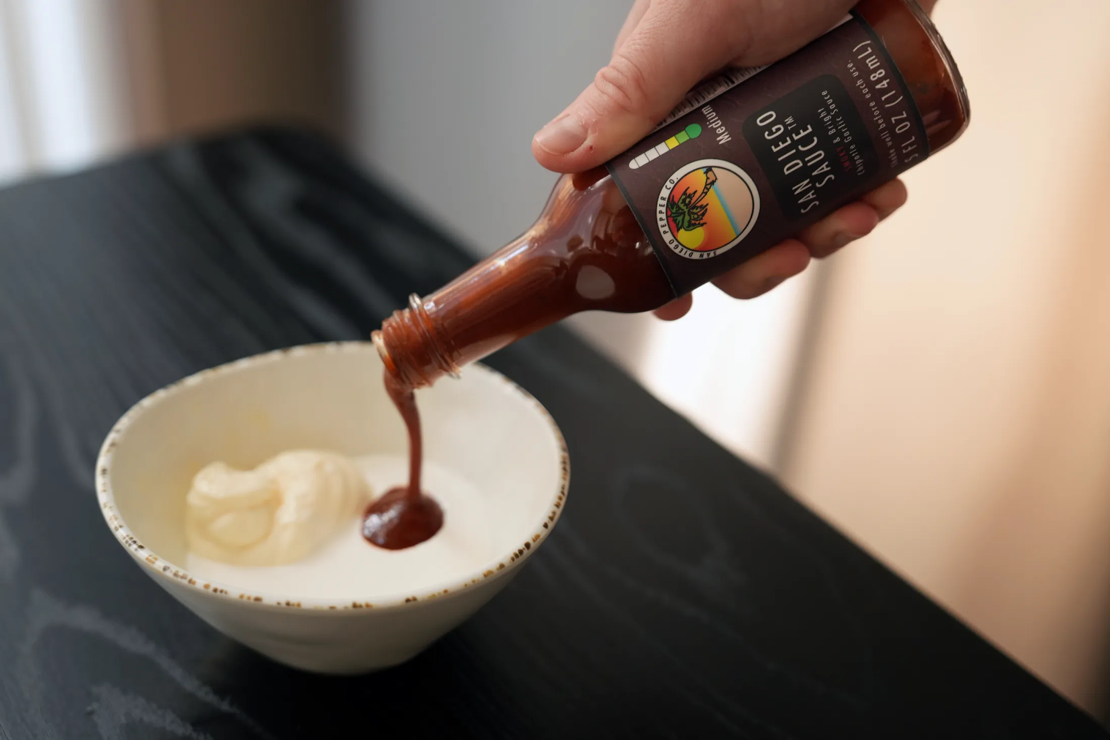 San Diego Sauce being poured into crema